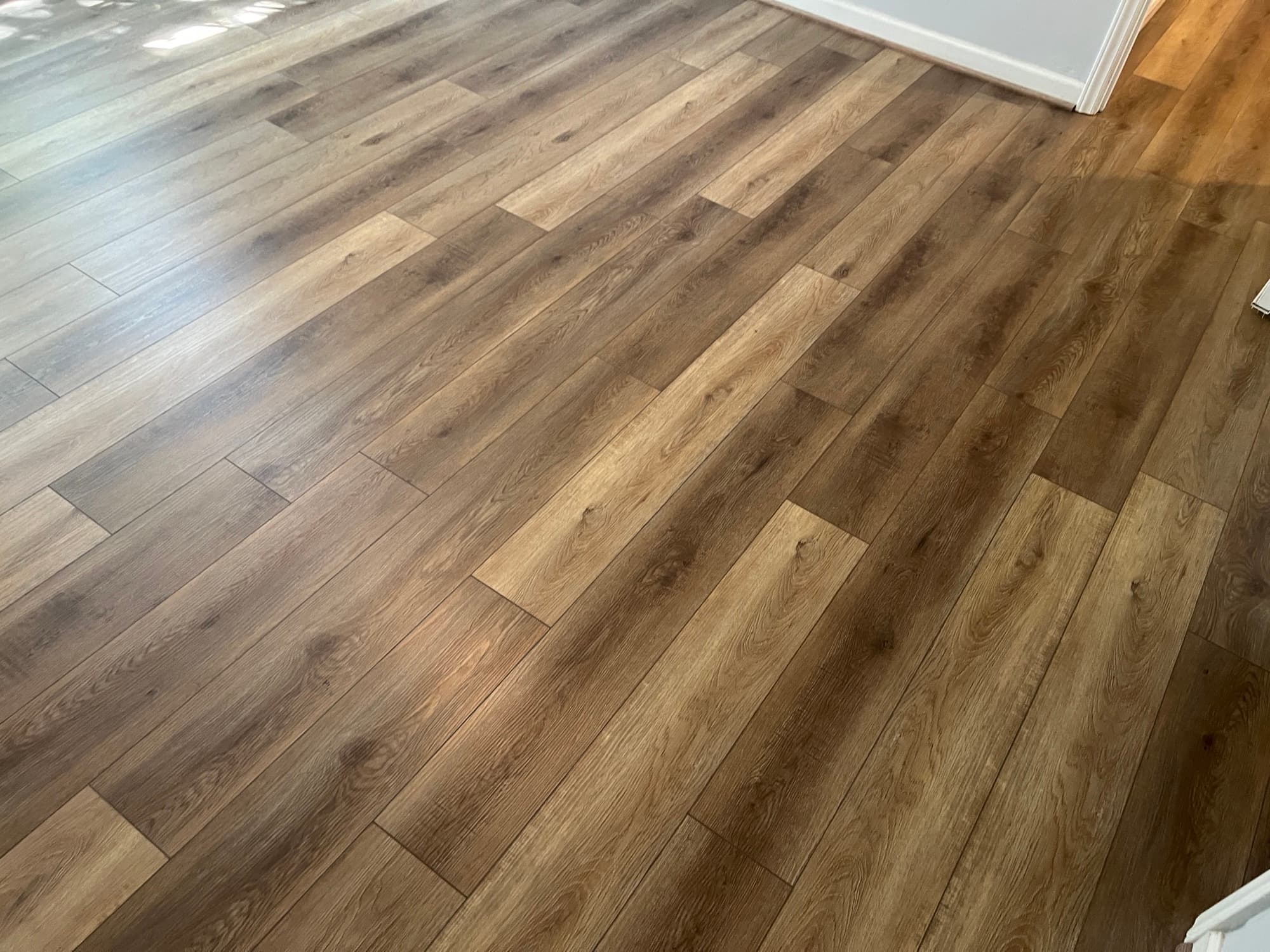 Luxury vinyl plank flooring installation with warm oak look planks installed in Clayton NC by 12th And Oak Floor Co.
