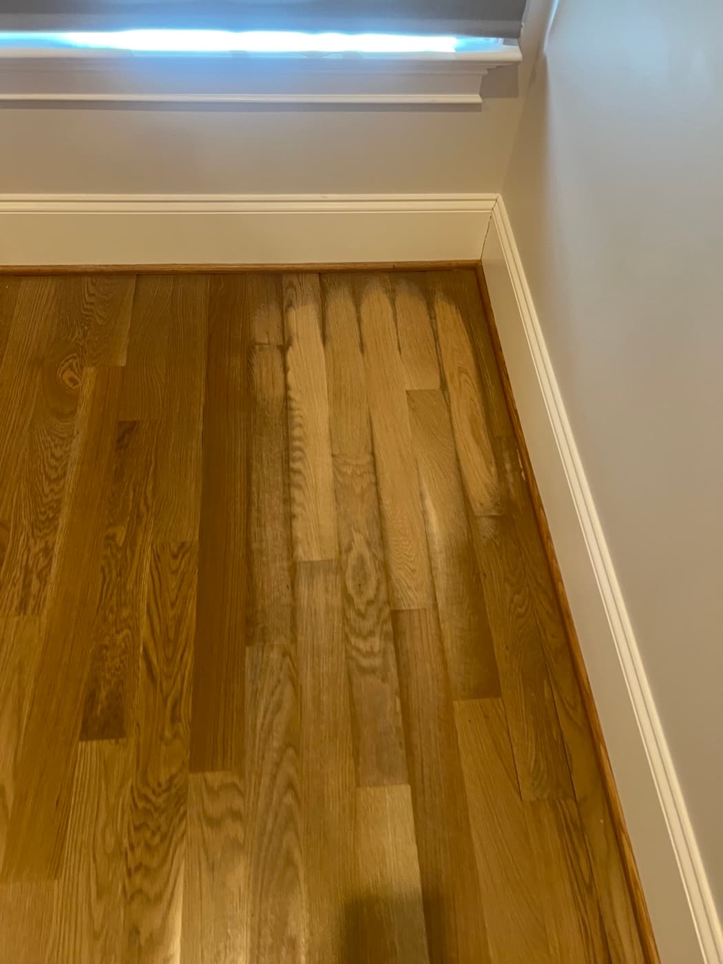 Crowned white oak hardwood floor boards caused by sanding while cupped in Bloomsbury Raleigh NC before repair