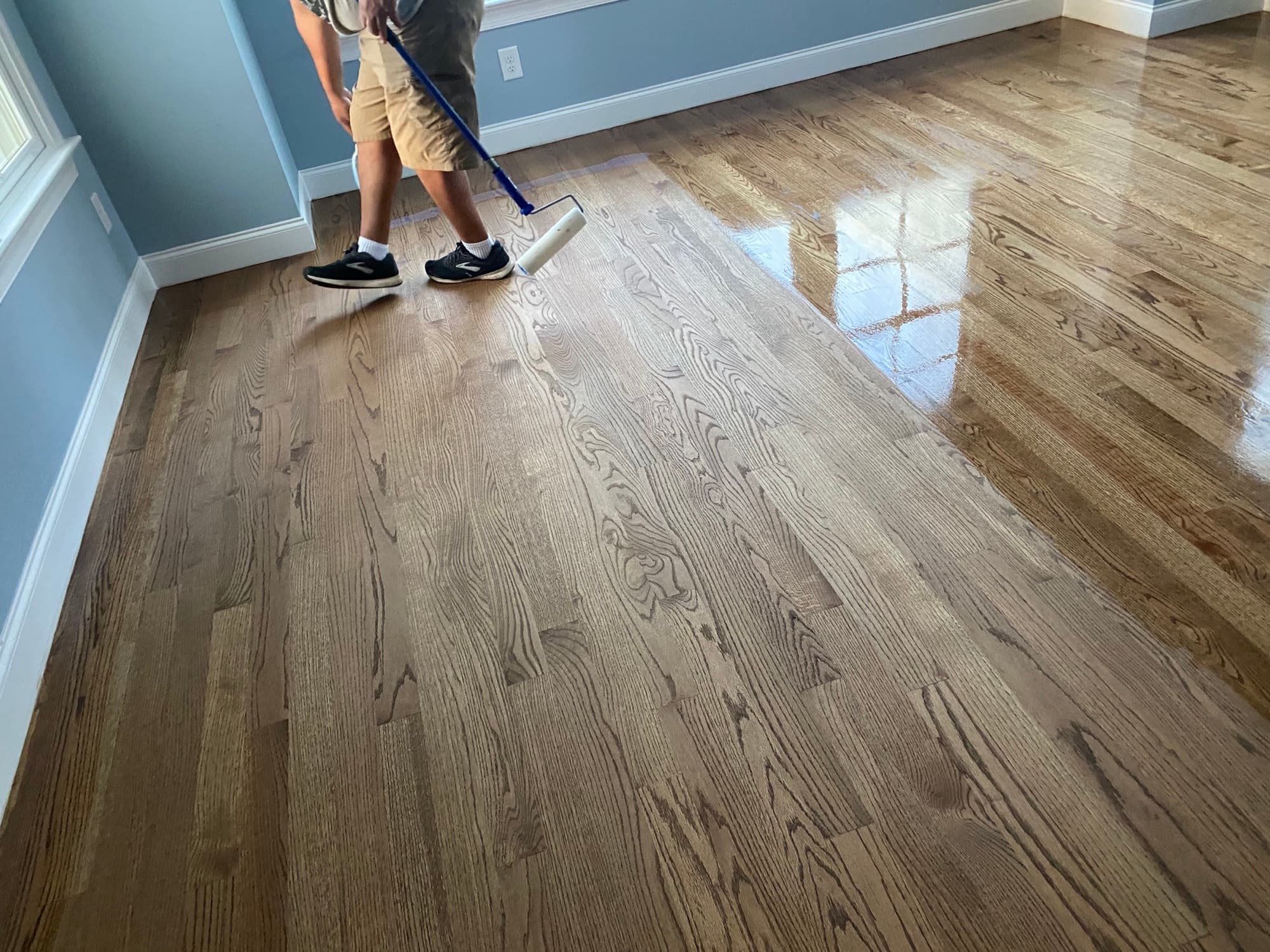 Hardwood floor recoating screen and recoat in progress with roller applicator on red oak floors by 12th And Oak Floor Co.