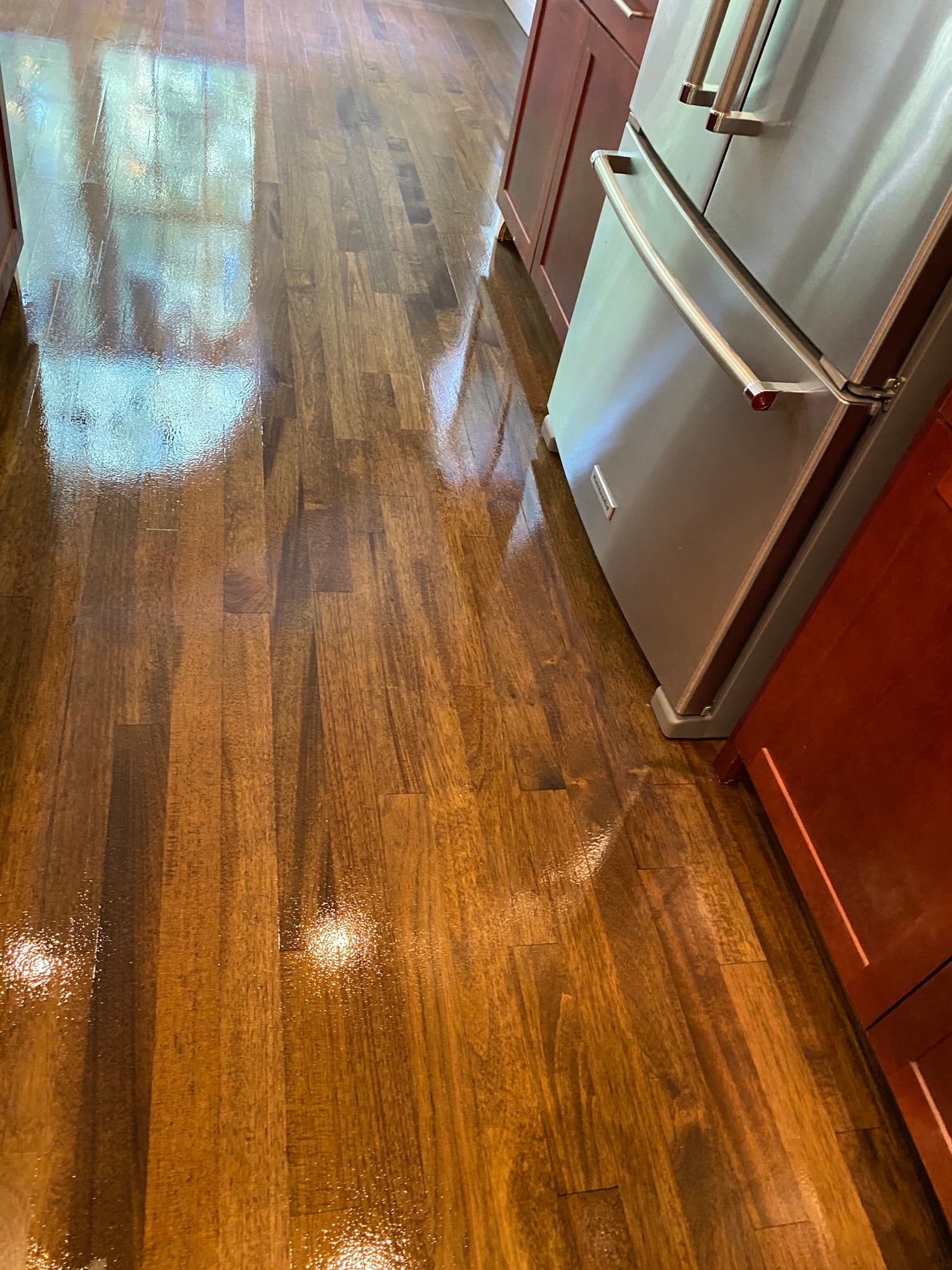 Repaired and refinished Brazilian oak floors in McGregor Downs Cary NC after water damage, custom Bona stain and Bona Traffic HD finish, repair invisible
