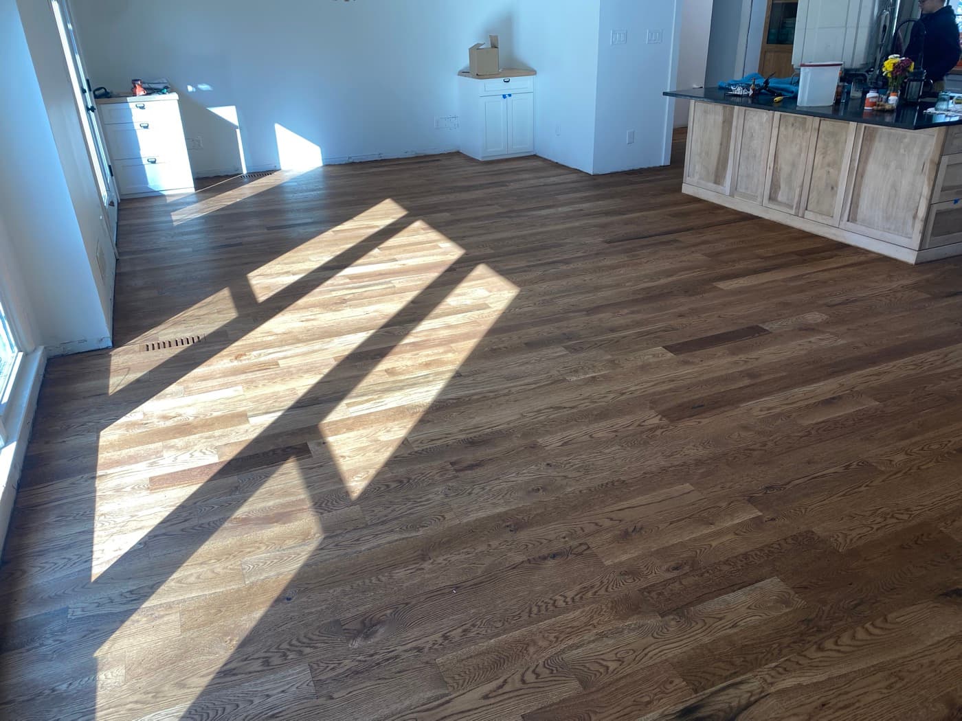Finished Pallmann Magic Oil 5-inch white oak living room wide shot with sunlight patterns Oak Park Raleigh NC