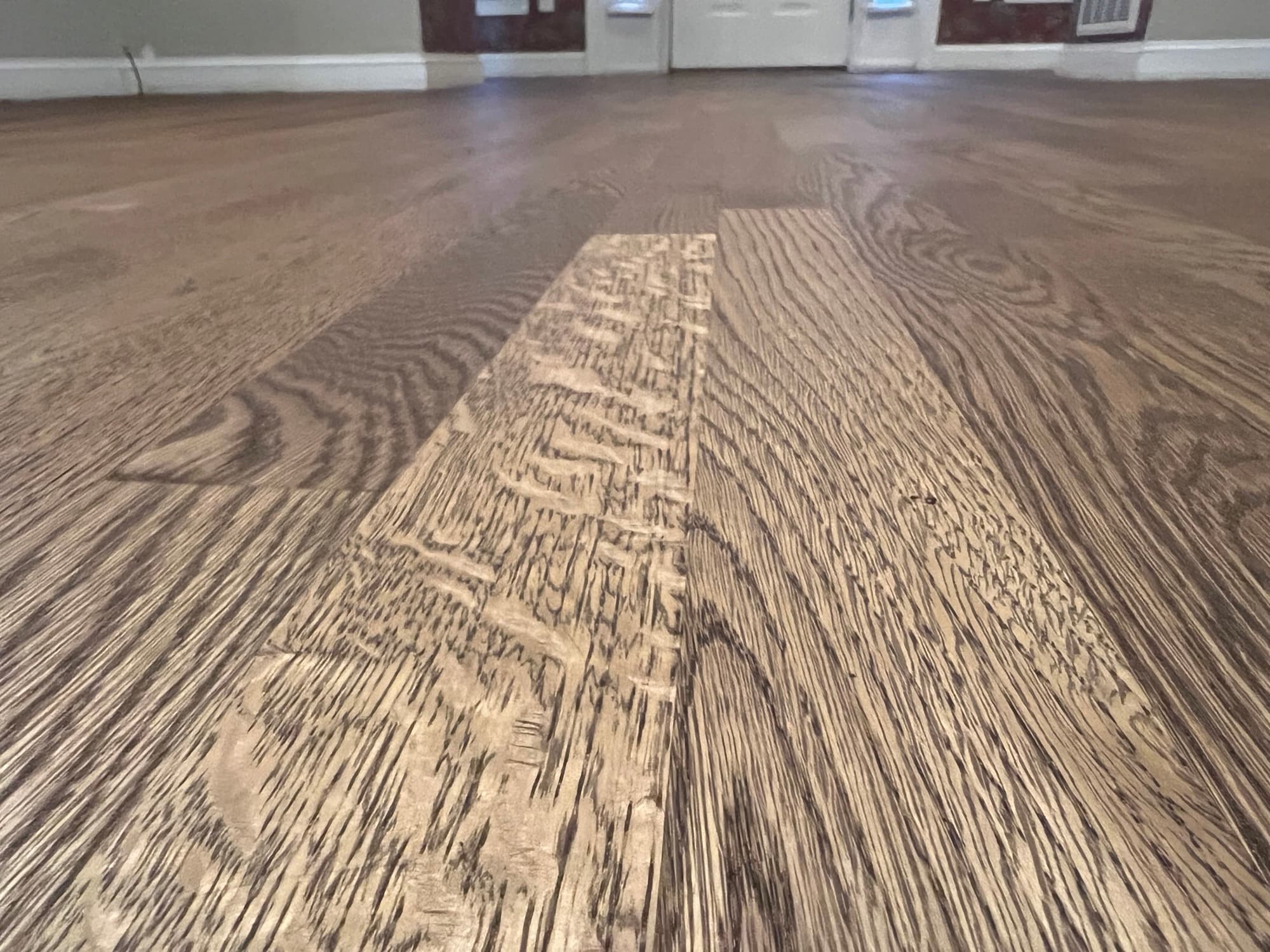 Low angle grain detail of finished red oak floor with DuraSeal Provincial stain in Wilson NC, dramatic cathedral grain figure