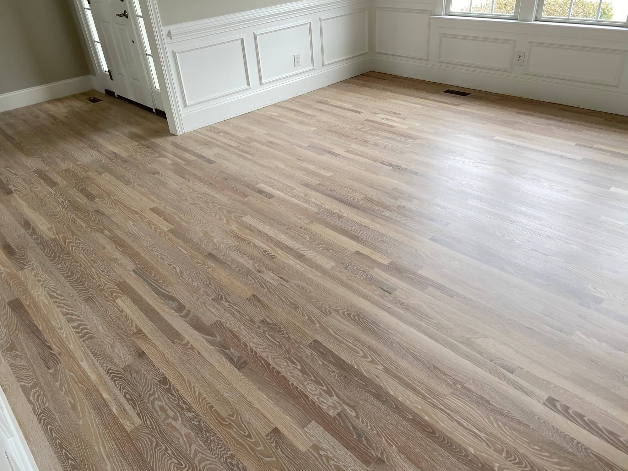 Refinished 2.25 inch white oak floors with Bona Craft Oil Frost in Heritage Wake Forest NC, light natural finish replacing dated orange ambered floor