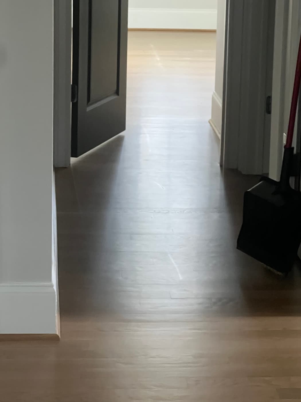 Prior finish failure with deep scratch marking on white oak hardwood floor before rescue refinishing in Raleigh NC