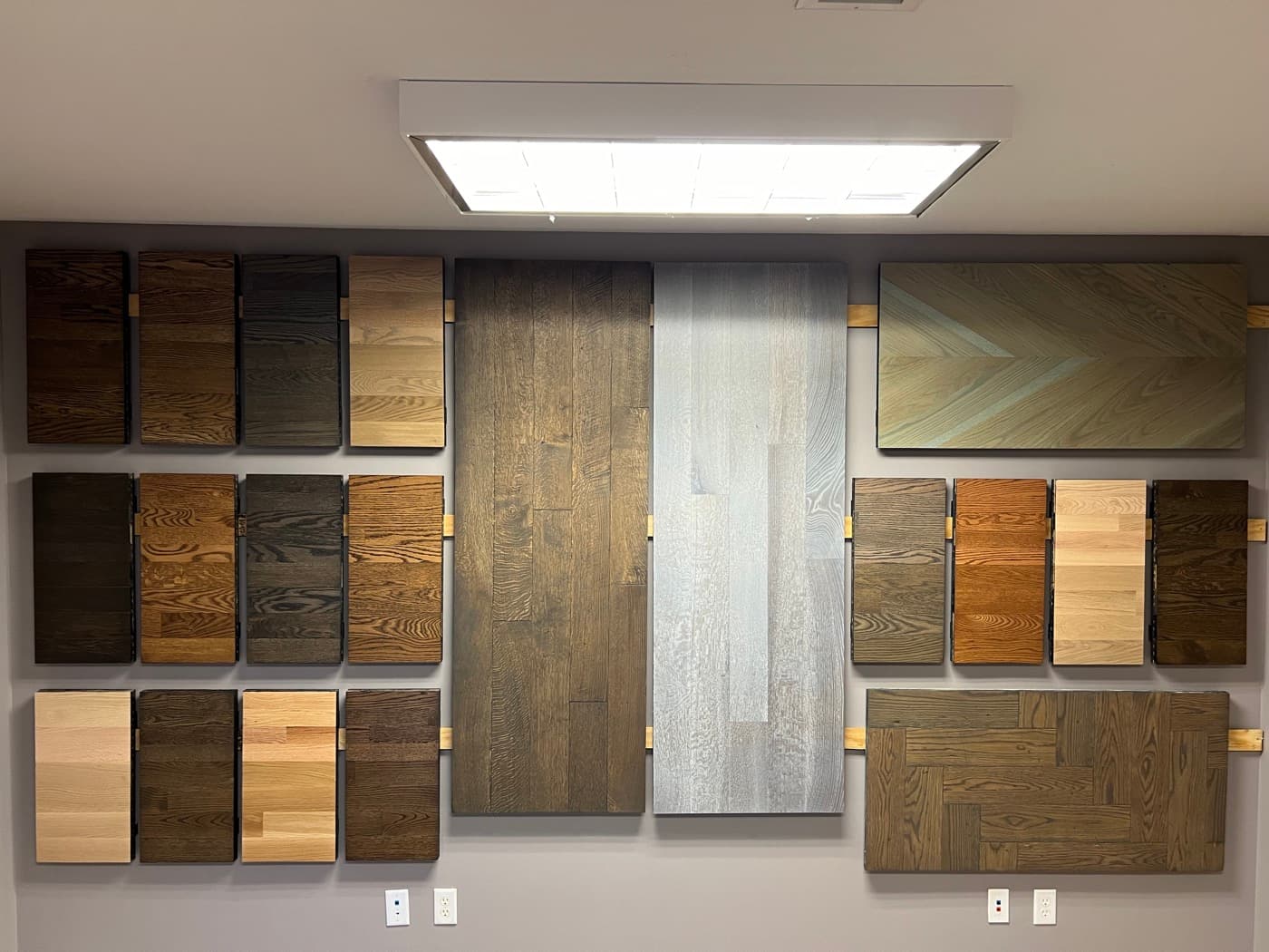 Stain sample wall showing red oak and white oak color options at 12th And Oak showroom Clayton NC