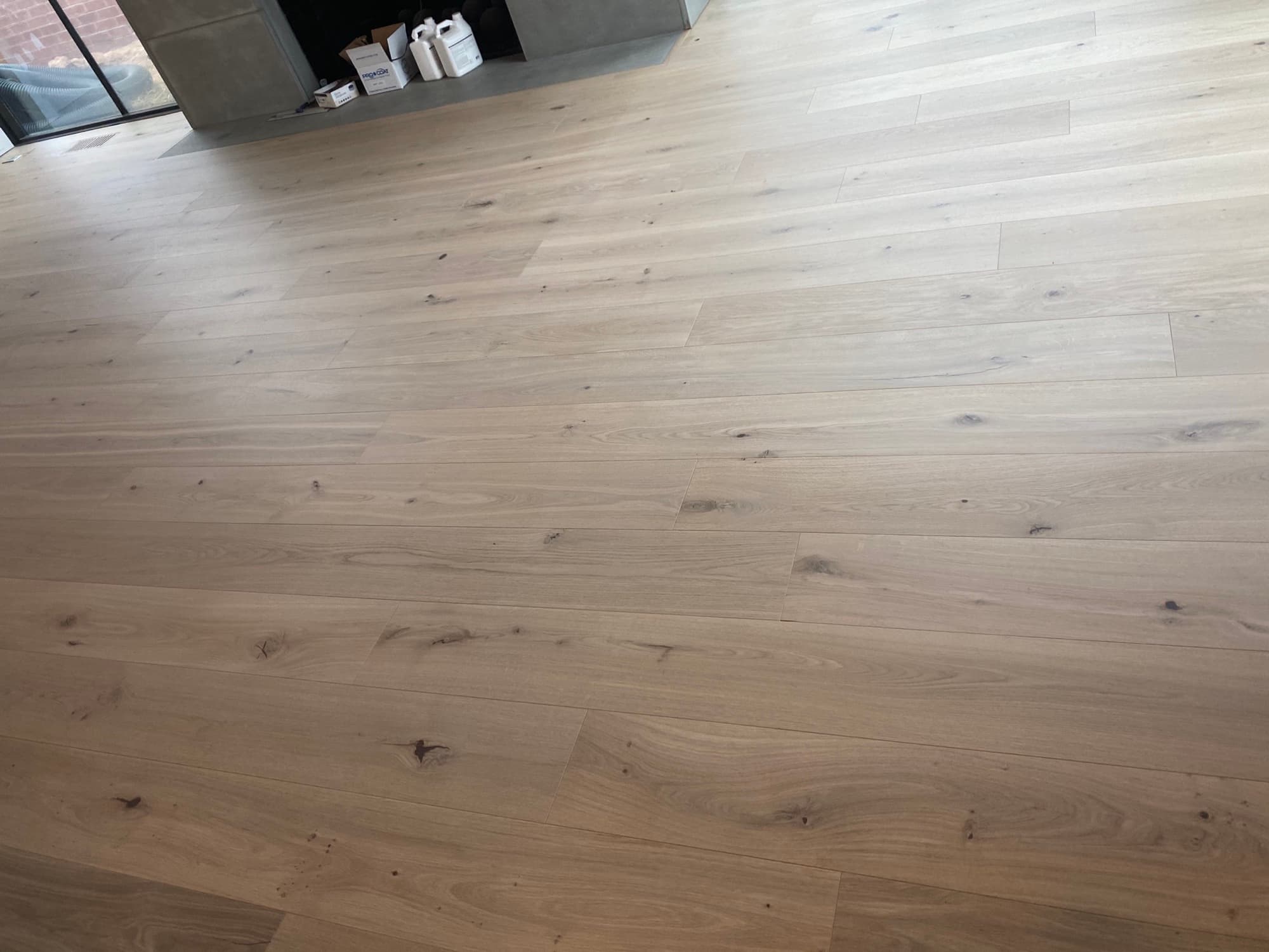Wide plank white oak hardwood floor installation in Holly Springs NC home by 12th And Oak Floor Co.